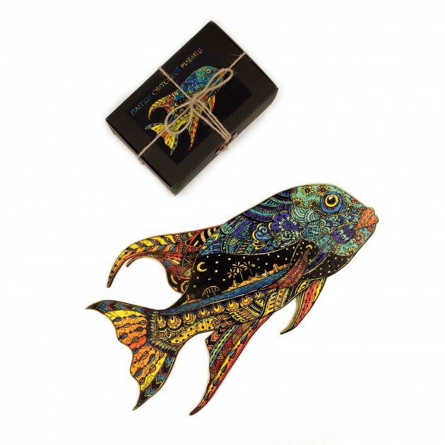 Colorful fish-shaped wooden puzzle with intricate patterns next to a black box with string #Box_Cardboard box