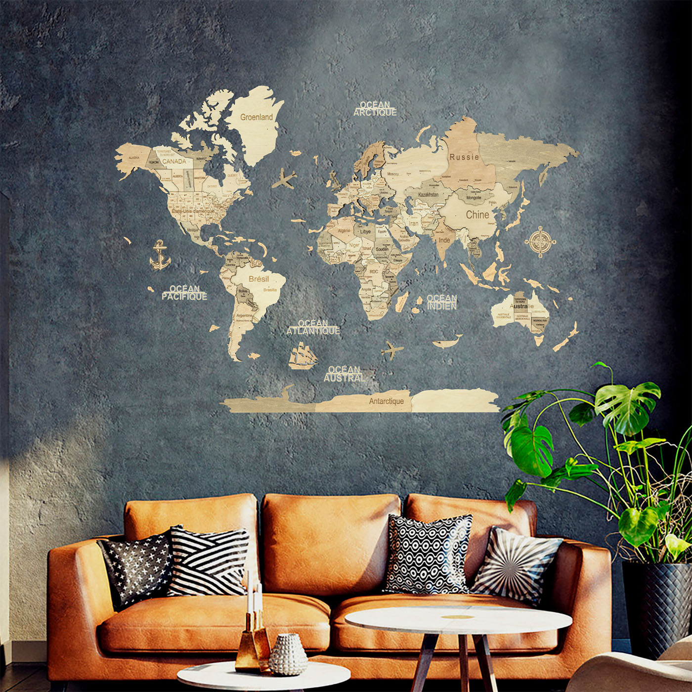 World map on a textured wall above a brown sofa with decorative pillows and a plant #Map language_French