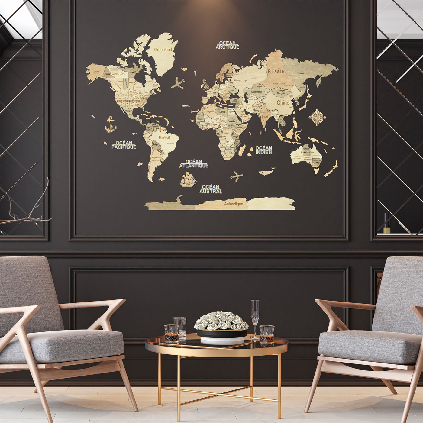 A large framed world map wall decor piece in a modern living room setting. The map features beige continents with vintage-style labels and black oceans, mounted on a dark charcoal wall between two gray armchairs and a small round coffee table #Map language_French